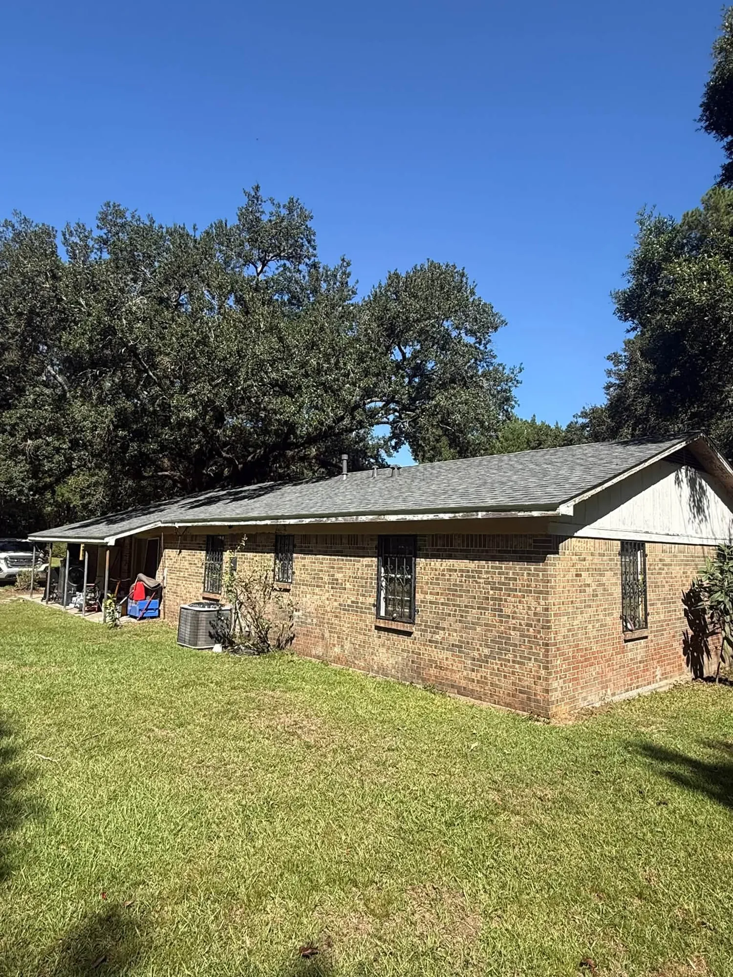 Brick ranch home with a new gray architectural shingle roof