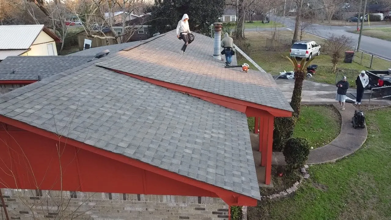 Roofing crew finishing a shingle replacement