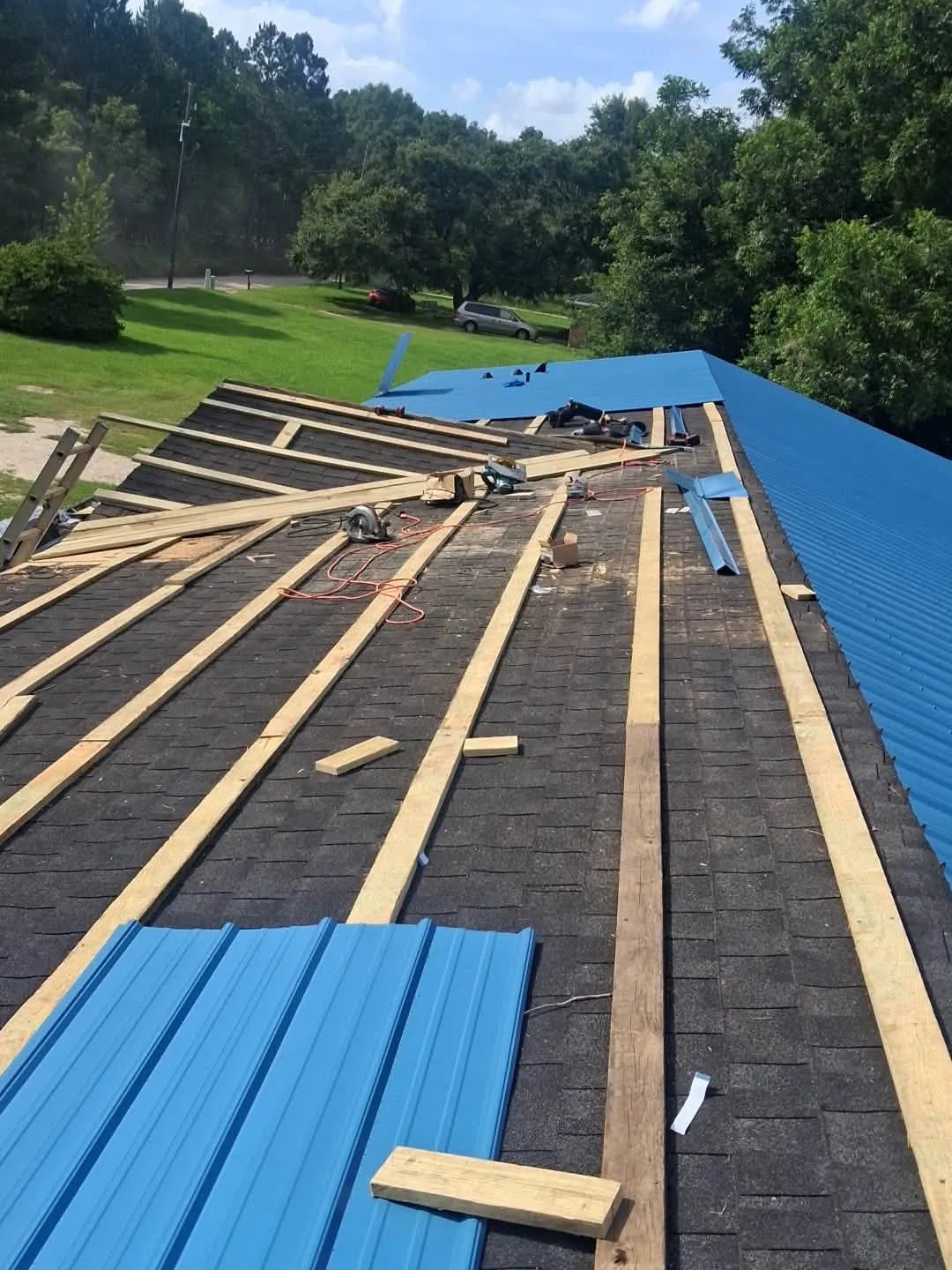 Wood purlins installed over an old roof, ready for metal panels