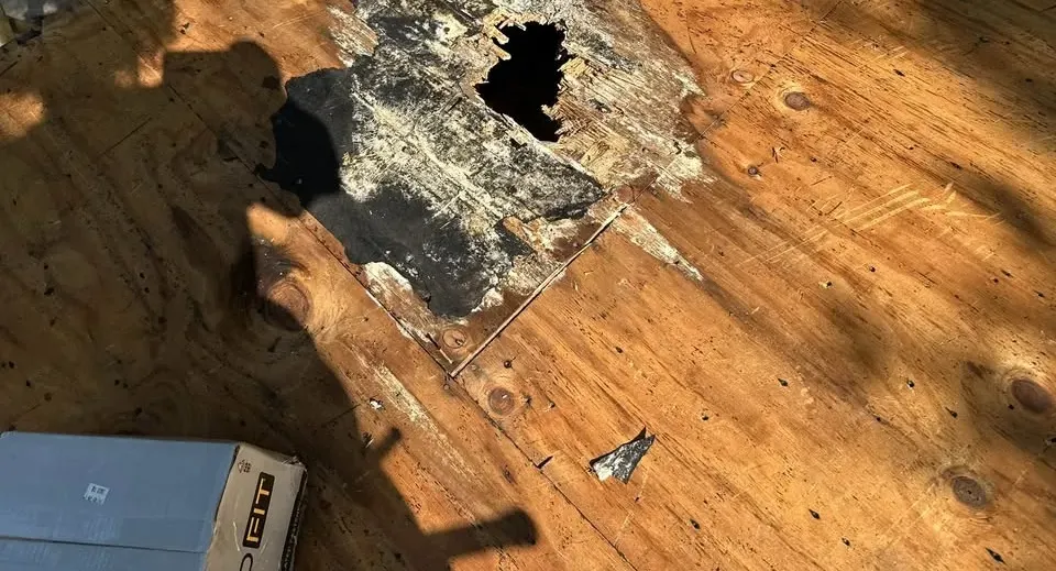 Rotted roof decking with a hole, found during a tear-off