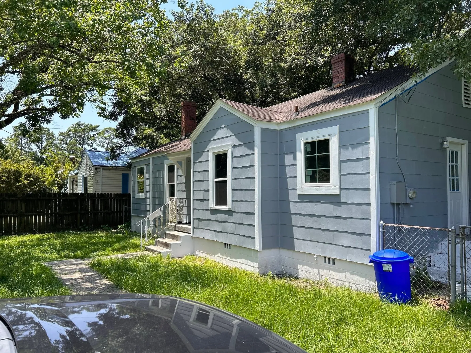 Small blue-gray home with siding and white trim