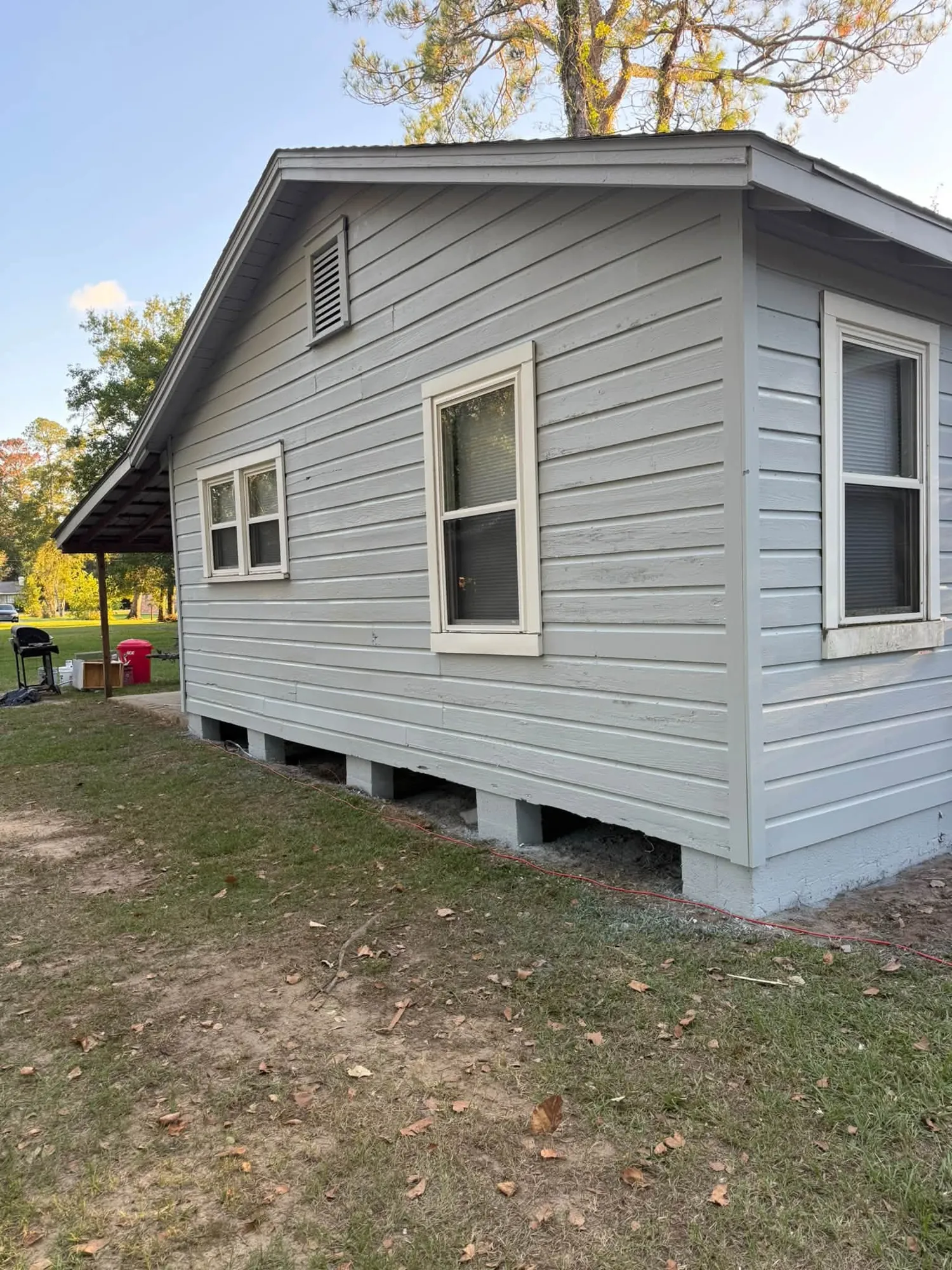 Side of a home with new light gray vinyl siding