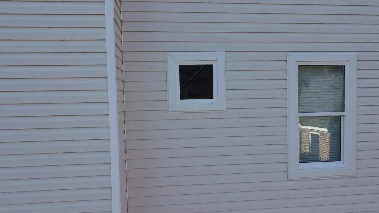 New vinyl siding with a small square window